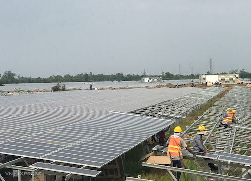 Công nhân hối hả lắp những tấm pin điện mặt trời cuối cùng tại một dự án điện mặt trời ở Long An. Ảnh: H.Thu